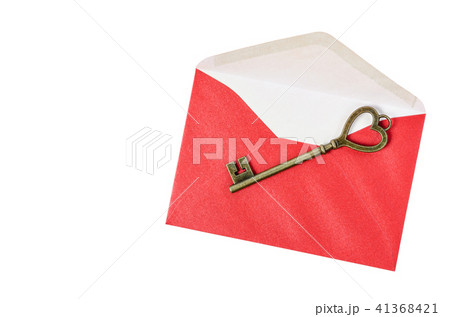Vintage key on red envelope. Vintage key on red envelope. 41368421