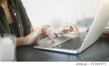 Close up of woman hands with a laptop at home Close up of woman hands with a laptop at home 41369575