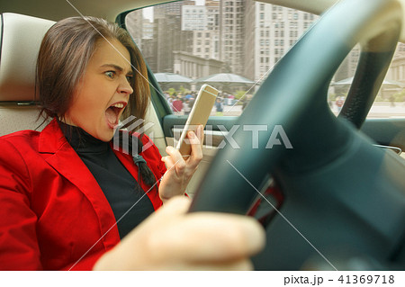 Driving around city. Young attractive woman driving a car Driving around city. Young attractive woman driving a car 41369718