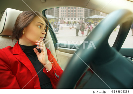 Driving around city. Young attractive woman driving a car 41369883