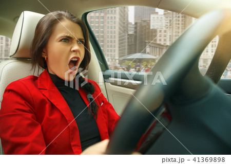 Driving around city. Young attractive woman driving a car 41369898