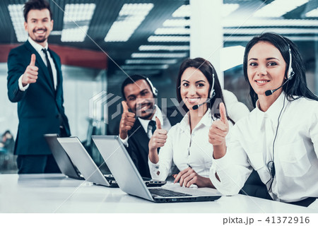 Happy multiracial call center team shows thumbs up 41372916