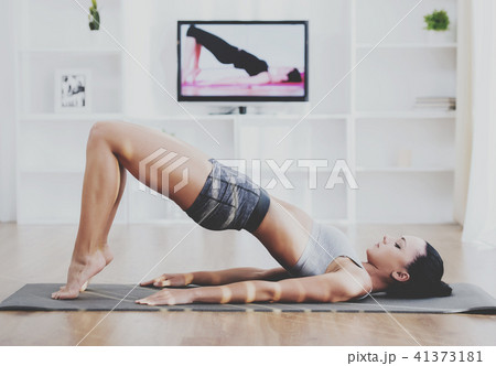 Beautiful girl engaged in yoga at home on gym mat 41373181