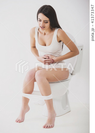 A beautiful girl is sitting on the toilet. Woman in panties relaxing on the  toilet with the phone. Pensive teenage girl sits with panties on the  toilet. 11025526 Stock Photo at Vecteezy