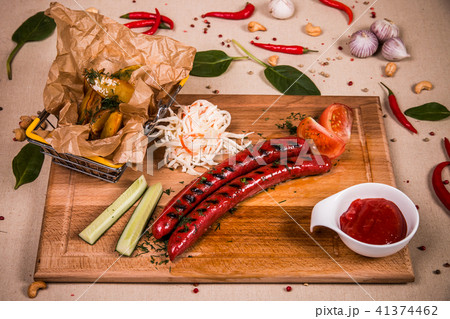 Grilled sausages with cucumber and ketchup Grilled sausages with cucumber and ketchup 41374462