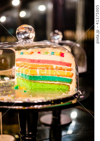 Rainbow cake under glass bell dome 41375005