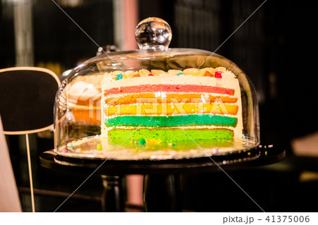 Rainbow cake under glass bell dome 41375006