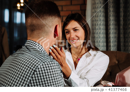 a girl in love looks at her man with eyes in love in a cafe 41377408