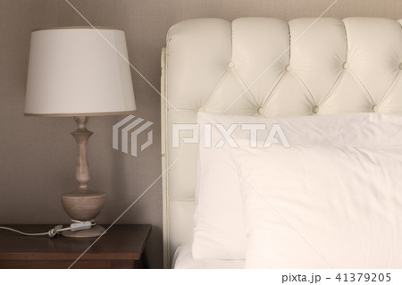 White pillow on white luxury bed in bedroom. 41379205