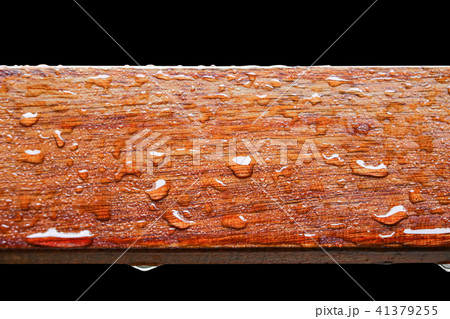 Drop of water on wood on black background 41379255