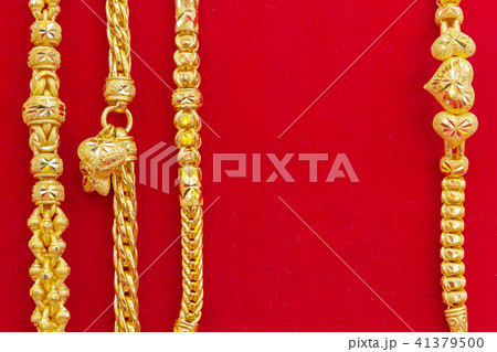 Luxury gold bracelets on red flannel. Luxury gold bracelets on red flannel. 41379500
