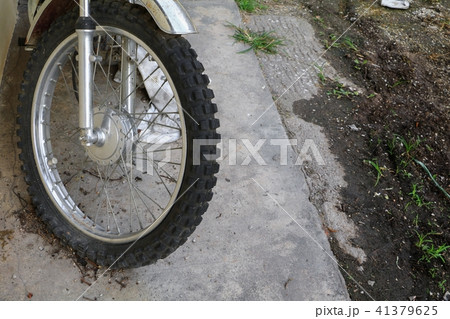 Close up wheel flat tire of the motorcycle old Close up wheel flat tire of the motorcycle old 41379625
