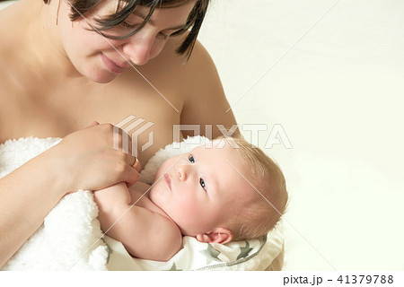 Breastfeeding of two month old blond baby boy Breastfeeding of two month old blond baby boy 41379788