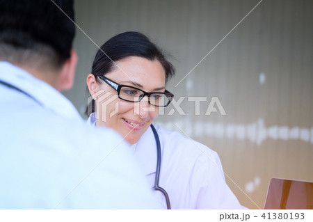 Senior Female doctor consults young Patient 41380193