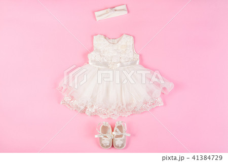 Beautiful baby dress with booties on a pink 41384729