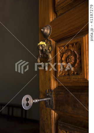 Big key and wooden door at the entrance of a templ 41387279