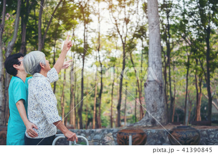 Smiling caregiver Senior nurse take care patient Smiling caregiver Senior nurse take care patient 41390845
