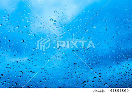 Drops of rain on blue glass background 41391369
