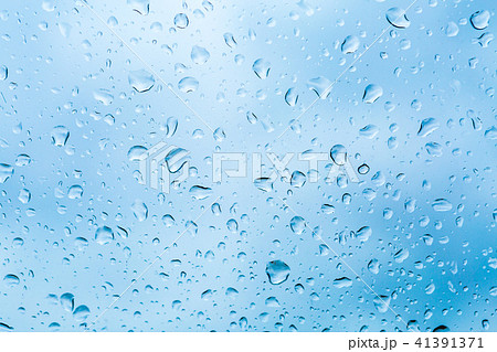 Drops of rain on blue glass background 41391371