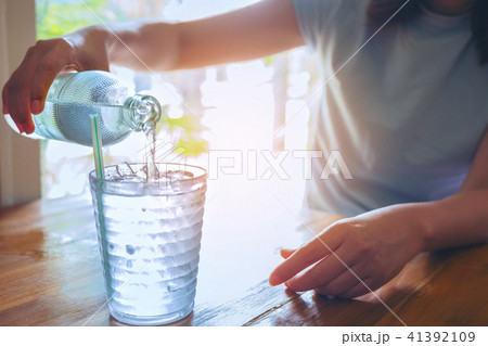 Hand women holding the glass bottle of water cool Hand women holding the glass bottle of water cool 41392109