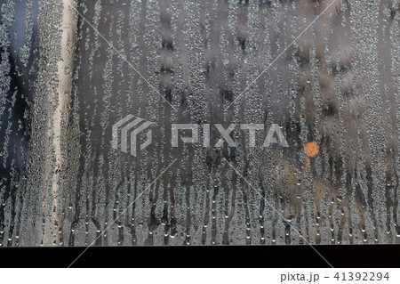 condensate flowing water on the window glass condensate flowing water on the window glass 41392294