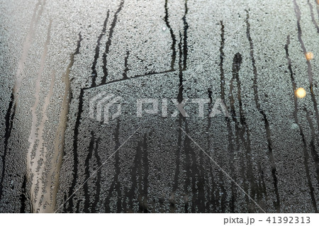 condensate flowing water on the window glass  41392313