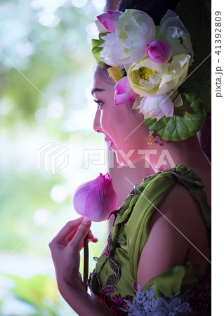 Beautiful Asian woman lotus on hand with Thai Beautiful Asian woman lotus on hand with Thai 41392809