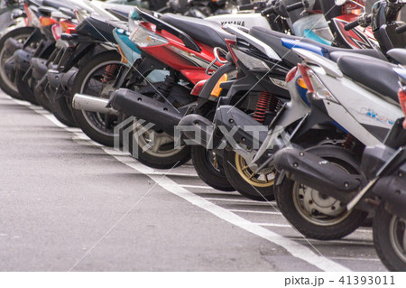 A row of motorcycle parking along the roadside 41393011