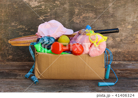 Cardboard box with sports stuff on old wooden Cardboard box with sports stuff on old wooden 41406324
