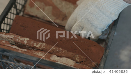 closeup worker taking brick cuts tile from container 41406886