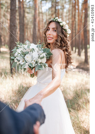 A cute curly woman in a white wedding dress 41410963