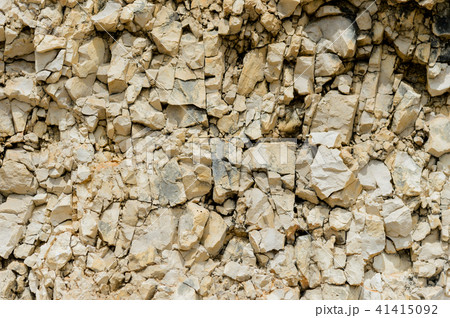 Textured stone background Rubble ballast in natural form in the rock wall Textured stone background Rubble ballast in natural form in the rock wall 41415092