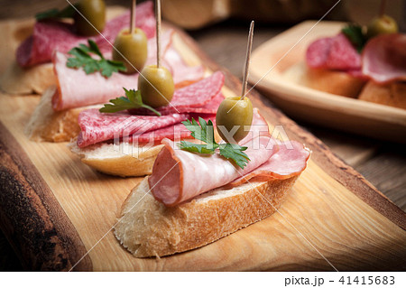 Tapas with sliced sausage, salami, olives Tapas with sliced sausage, salami, olives 41415683