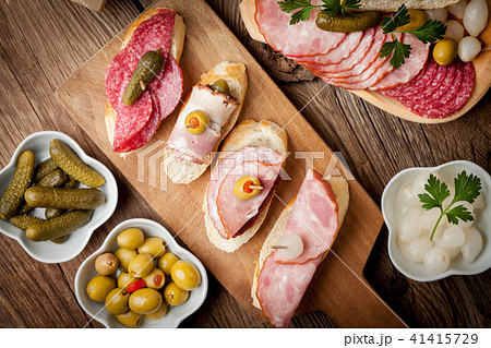 Tapas with sliced sausage, salami, olives Tapas with sliced sausage, salami, olives 41415729