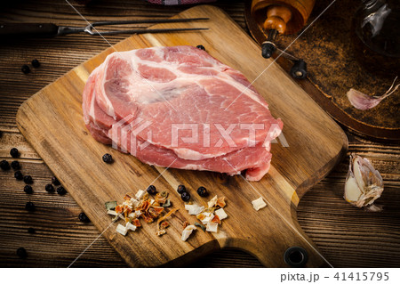 Slices of raw pork neck. 41415795