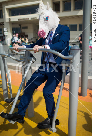 Comical man in elegant suit and funny mask Comical man in elegant suit and funny mask 41419751
