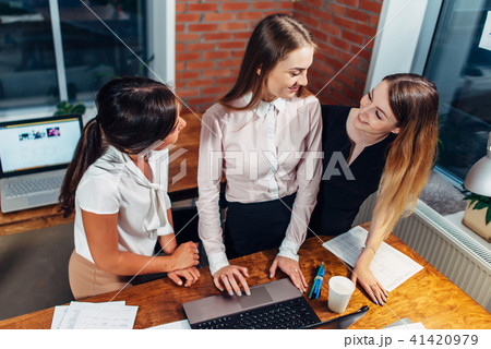 Creative team working on new project together looking and listening to their partner standing around Creative team working on new project together looking and listening to their partner standing around 41420979