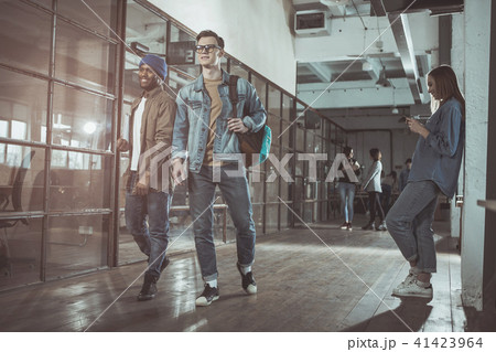 Optimistic young men are standing in office Optimistic young men are standing in office 41423964
