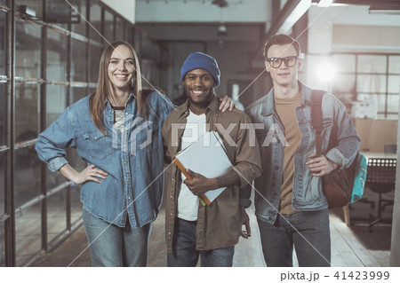 Optimistic qualified colleagues are posing with smile Optimistic qualified colleagues are posing with smile 41423999