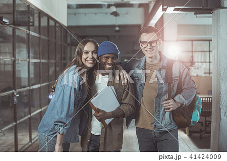 Joyful creative people are standing and laughing Joyful creative people are standing and laughing 41424009