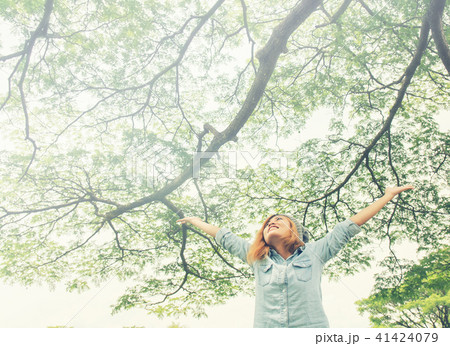 Young woman open arms standing in fresh spring Young woman open arms standing in fresh spring 41424079