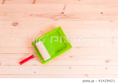 Paint roller brush on wood background 41429421