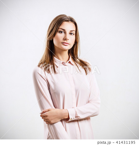 Beautiful young woman posing in romantic pink dress. 41431195