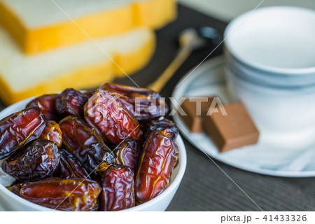 Dry dates fruit in small bowl Dry dates fruit in small bowl 41433326