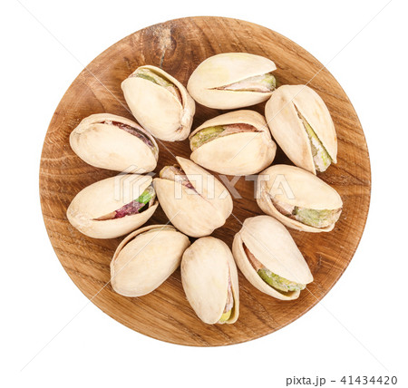 Pistachios in wooden bowl isolated on white background, top view. Flat lay 41434420