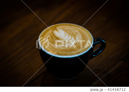 Coffee cup with latte art on wooden background .  41438712