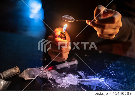 Male Junkie hand preparing heroin dose Male Junkie hand preparing heroin dose 41440588