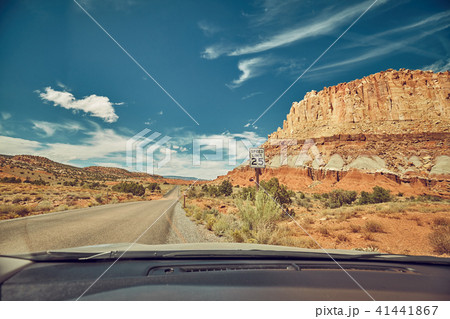 Retro toned road seen through a windshield Retro toned road seen through a windshield 41441867
