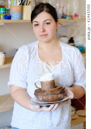 pottery business woman hold craft crockery plate pottery business woman hold craft crockery plate 41443500