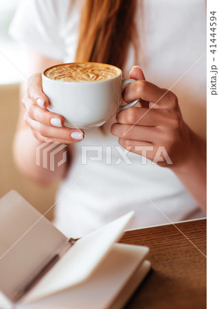 Beautiful girl in cafe with tasty capuccino. Beautiful girl in cafe with tasty capuccino. 41444594